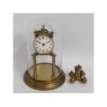A brass anniversary clock with glass dome, 10.75in
