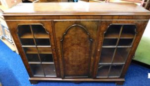 A antique style walnut bookcase with glazed doors, fault to one piece of front trim, 45in high x 52.