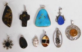 A quantity of silver & white metal pendants includ