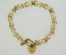 A 9ct gold three bar gate bracelet with padlock, 6
