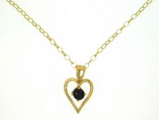 A 9ct gold pendant set with 'black' sapphire & chain, 18in long, 1.5g