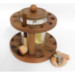 A pipe rack with tobacco jar, pipe & pipe cleaner,