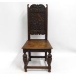 A carved oak hall chair, 43in high to back