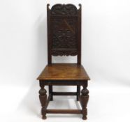 A carved oak hall chair, 43in high to back