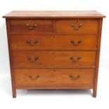 An antique oak chest of drawers with brass handles