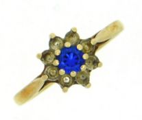 A 9ct gold ring set with blue & white paste stones