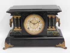 A wooden architectural mantle clock, 17.75in wide