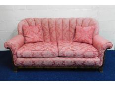 A c.1940's upholstered two seater sofa with scallo
