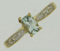 A 9ct gold ring set with diamond & topaz, bent cla