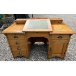 An early 20thC. light oak writing desk, 53.5in wid