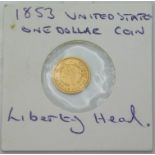 An 1853 US gold one dollar coin with Liberty head