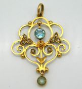 An Edwardian 9ct gold pendant set with topaz & pea