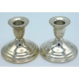 A pair of sterling silver candle holders, probably