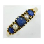 A yellow metal ring set with pearl & sapphire, tes