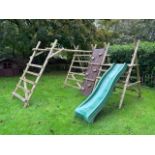 Communal space: A child's wooden garden climbing frame with slide