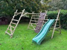 Communal space: A child's wooden garden climbing frame with slide