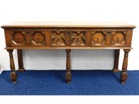 A Jacobean style oak sideboard with three drawers,