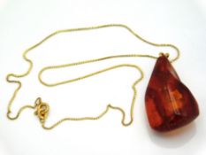 An 18ct gold chain, 13.5in long, set with amber pe