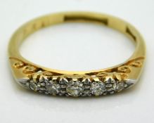 An antique 18ct gold carved ring set with five sma