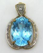 A 9ct gold pendant set with blue topaz & small dia