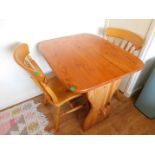 Mariner's Cottage: A small pine trestle table with