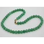 A jade necklace measuring 18in long, beads 8mm, 44