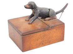 An antique articulated cigarette box with dog tail