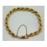 A yellow metal rope bracelet with diamond in link, tests electronically as 9ct gold, 7in long, 4.6g