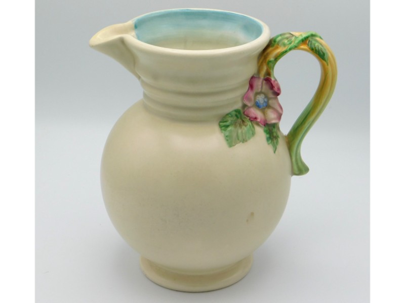 A Clarice Cliff jug with organic handle, 8.75in ta