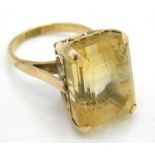 A 14ct gold ring set with yellow topaz, 10.6g, siz