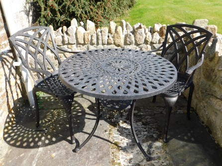 A 'Lazy Susan' aluminium dining table & two chairs