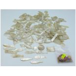 A large quantity of Chinese mother of pearl counters including fish, approx. 250g, twinned with a sm
