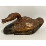 A large, carved wooden duck, 20in long