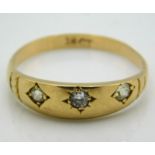 A antique 18ct gold ring set with three diamonds,