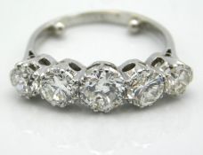 An antique five stone platinum ring set with appro