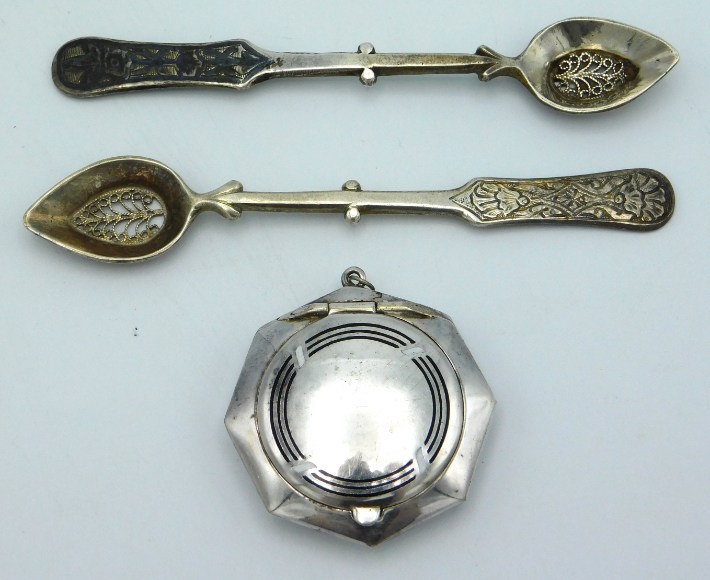 Two white metal spoons with filigree work bowls tw