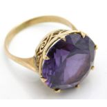 A yellow metal ring set with amethyst, tests elect