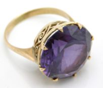 A yellow metal ring set with amethyst, tests elect