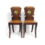 A pair of 19thC. mahogany hall chairs with hand pa