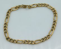 A 9ct gold Figaro link bracelet, fault to link & c