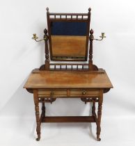 An antique dressing table with fitted brass candel