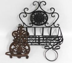 A cast iron wall mounted pot holder with hinged re