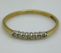 A 9ct gold ring set with seven small diamonds, 1.5