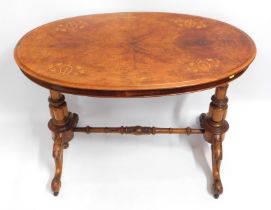 A 19thC. oval walnut table with inlaid top, some f