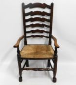 An antique ladder back chair with rush seat, 43.5i