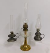 Three French oil lamps including one brass in art