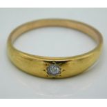 A yellow metal ring set with 0.1ct of diamond, tes