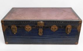 An antique shipping trunk with ostrich skin top &