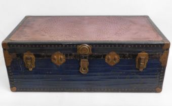 An antique shipping trunk with ostrich skin top &