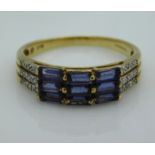 A 9ct gold ring set with small diamonds & blue paste stones, 2.6g, size R/S